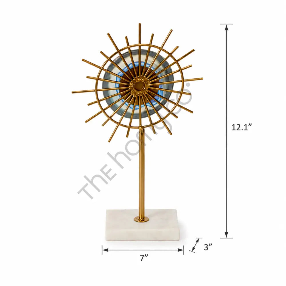 Gold sunburst sculpture with a blue accent center on a marble base for modern home decor. - 3