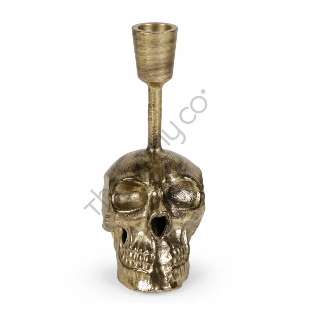 Antique gold skull taper candle holder with a detailed skull base for gothic home decor and Halloween styling.