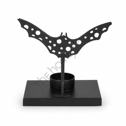 Black metal bat silhouette tealight candle holder for gothic Halloween tabletop decor.