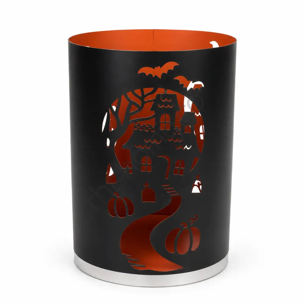 Black metal haunted house lantern with intricate mansion cutouts for Halloween home decor.