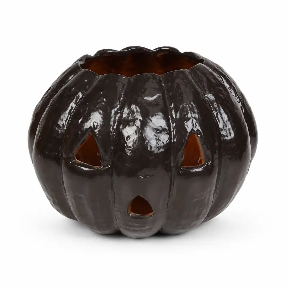 Glossy black ceramic jack-o'-lantern pumpkin candle holder for spooky Halloween home decor.
