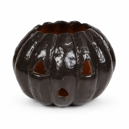Glossy black ceramic jack-o'-lantern pumpkin candle holder for spooky Halloween home decor.