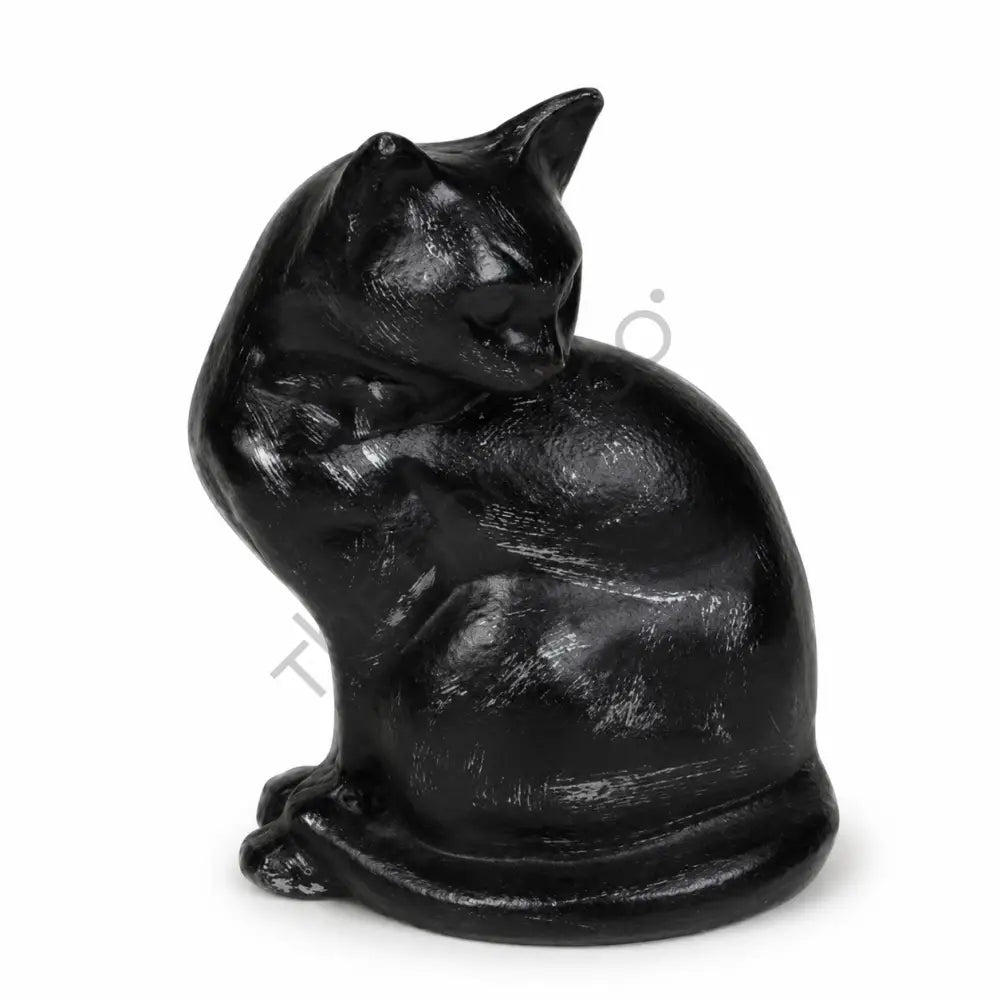Sleek glossy black sitting cat sculpture with a curled tail for modern home decor.
