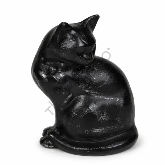 Sleek glossy black sitting cat sculpture with a curled tail for modern home decor.