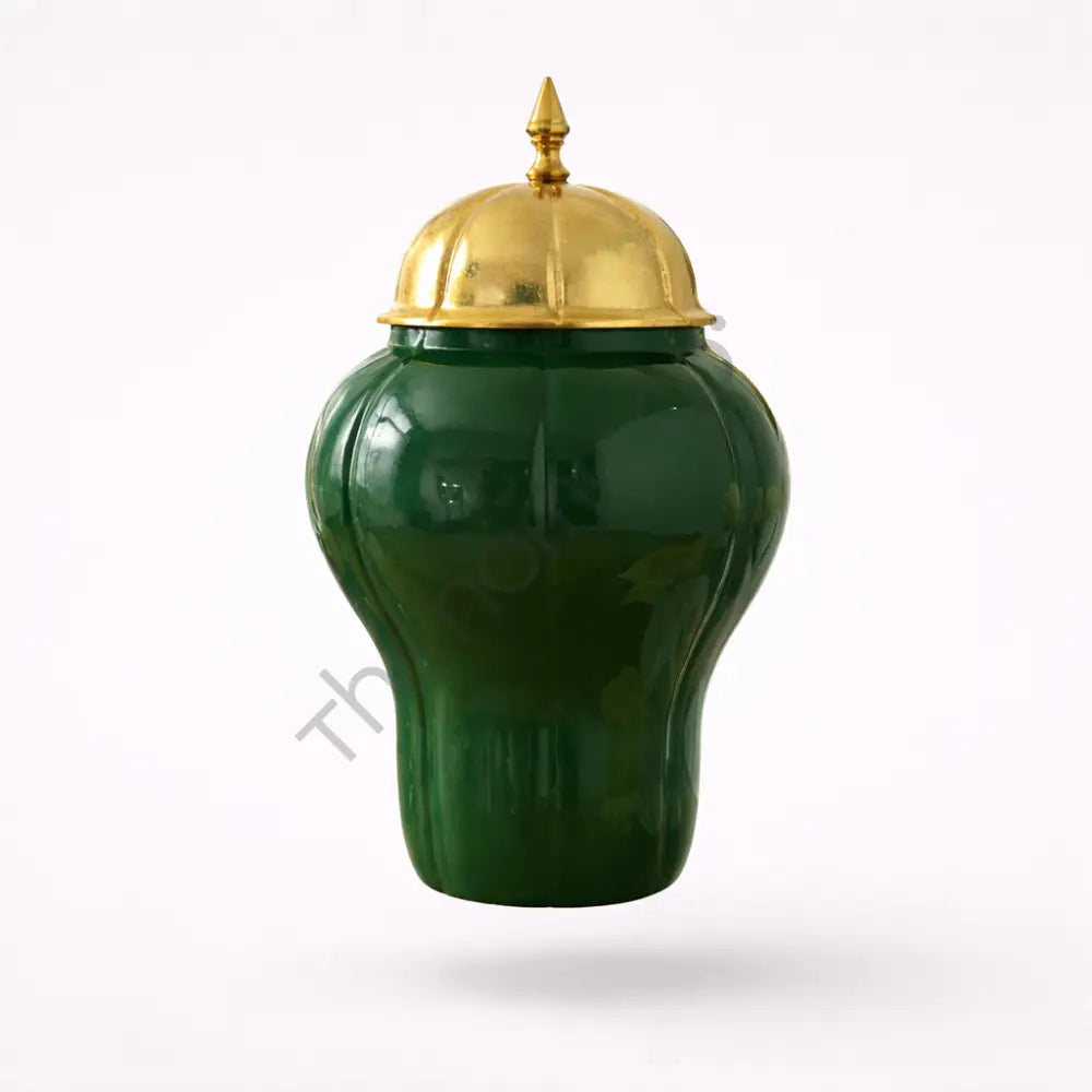 Elegant green ceramic storage jar with a luxury gold lid for sophisticated home decor.