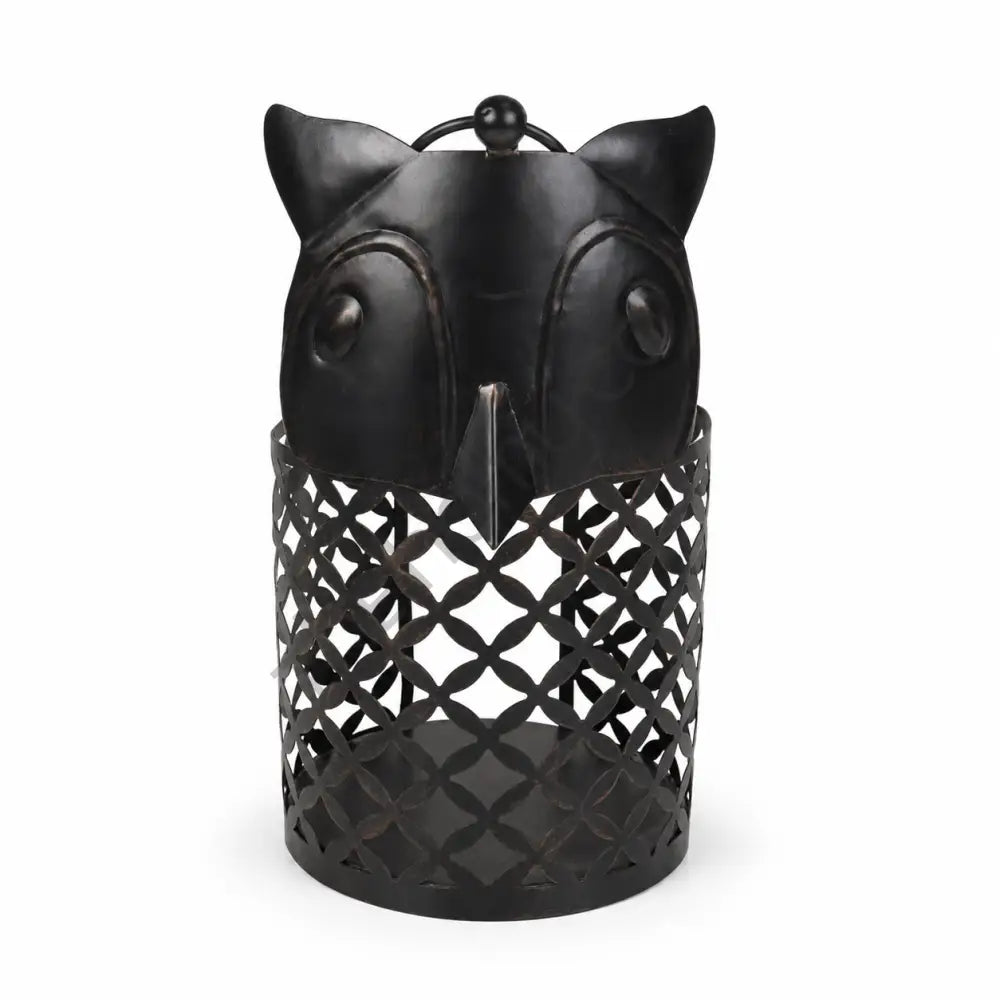 Rustic black owl-shaped metal lantern with lattice cutout design for Halloween and gothic home decor.