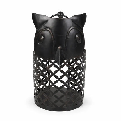 Rustic black owl-shaped metal lantern with lattice cutout design for Halloween and gothic home decor.