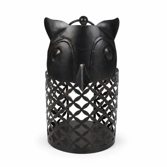 Rustic black owl-shaped metal lantern with lattice cutout design for Halloween and gothic home decor.