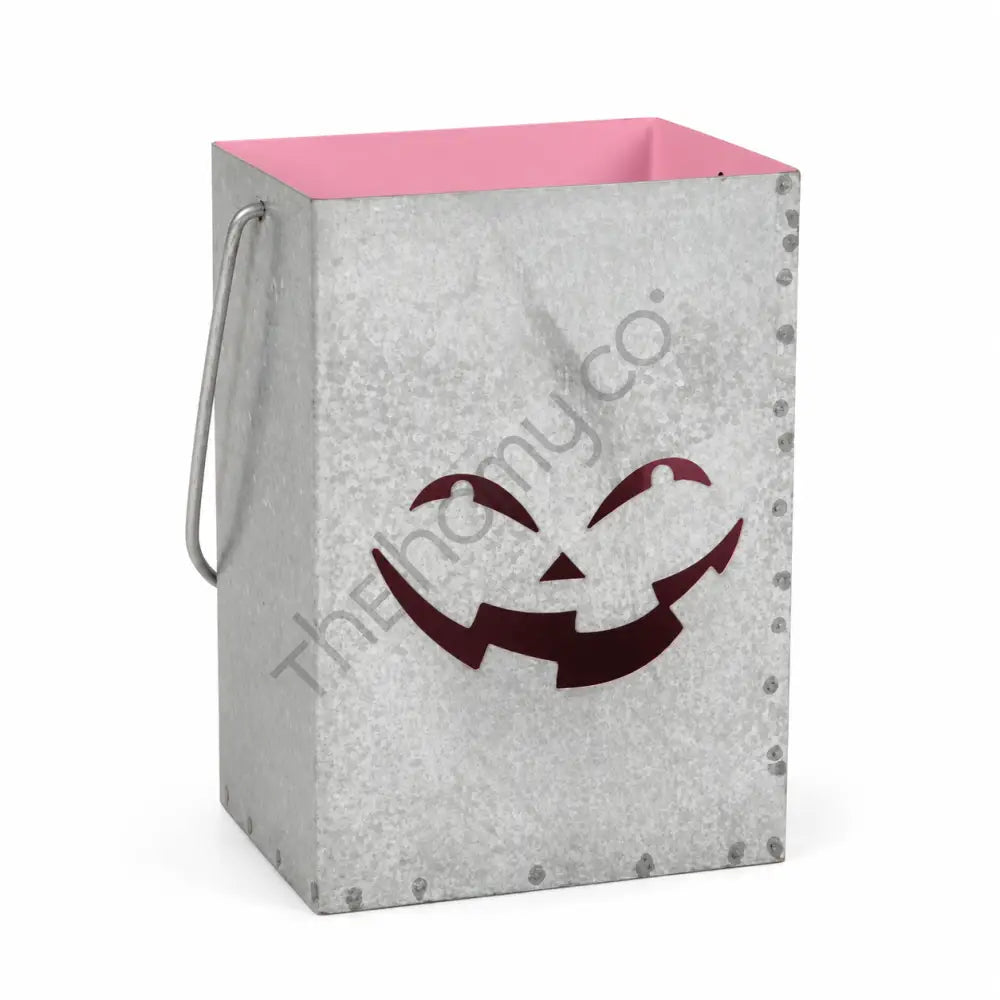 Galvanized metal Halloween jack-o-lantern pumpkin lantern bucket with a smiling face cutout and pink interior for farmhouse holiday decor.