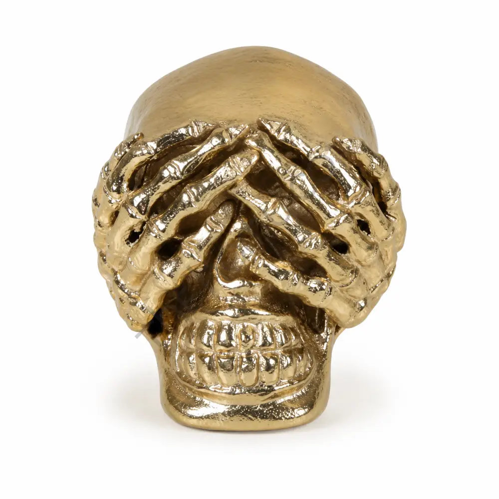 Artistic gold skull showpiece with hand-over-eyes design for modern home decor.