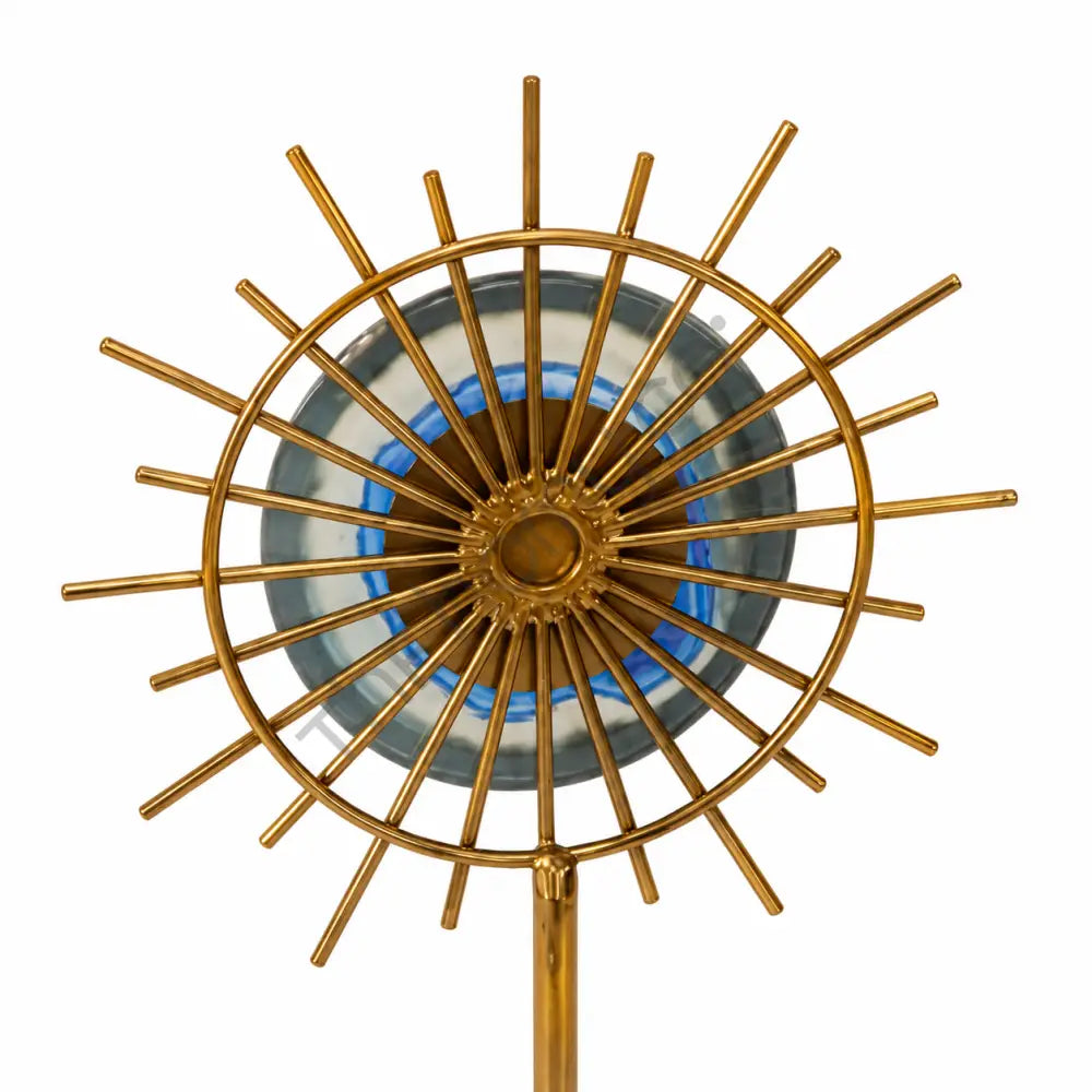 Gold sunburst sculpture with a blue accent center on a marble base for modern home decor. - 2