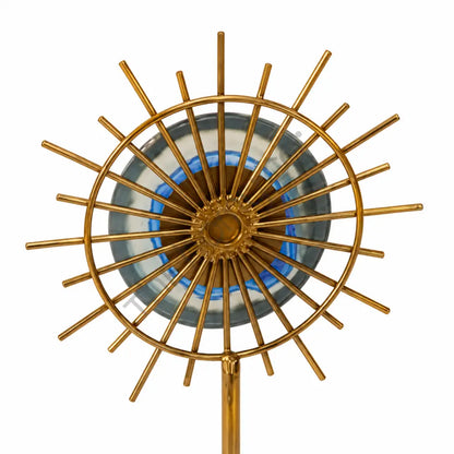 Gold sunburst sculpture with a blue accent center on a marble base for modern home decor. - 2