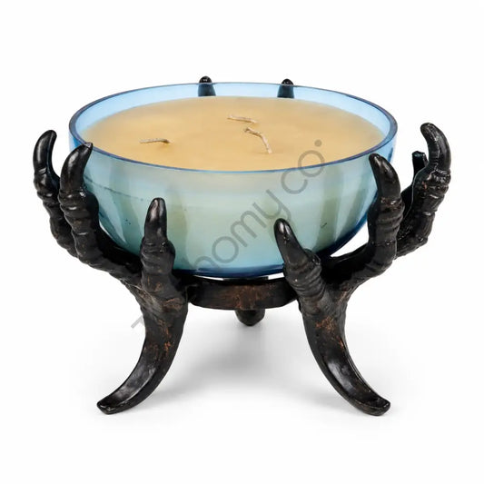 Gothic black skeletal claw hand holding a blue glass bowl for Halloween candle decor.