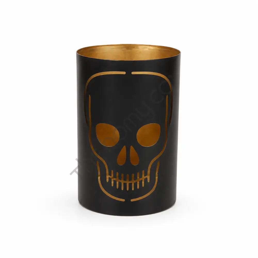 Black metal skull candle holder with gothic cutout design and gold interior for Halloween decor.