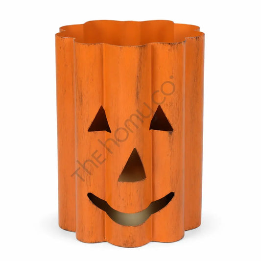 Rustic orange metal Halloween pumpkin lantern with a jack-o-lantern cutout face for spooky home decor.
