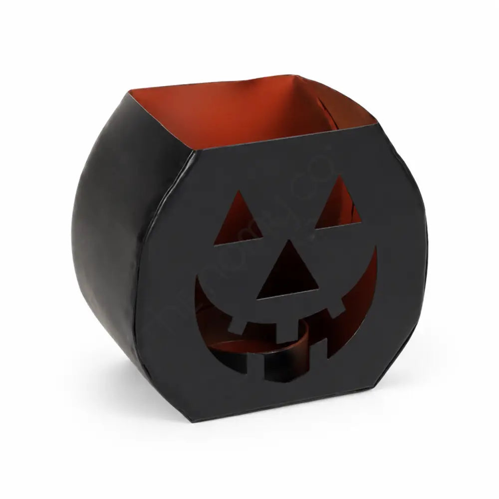 Black matte metal Halloween pumpkin lantern candle holder with orange interior and jack-o-lantern cutout design.