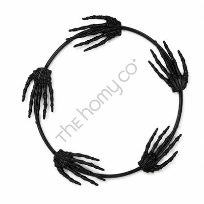 Black circular skeleton hand wreath for Halloween gothic wall and door decor.