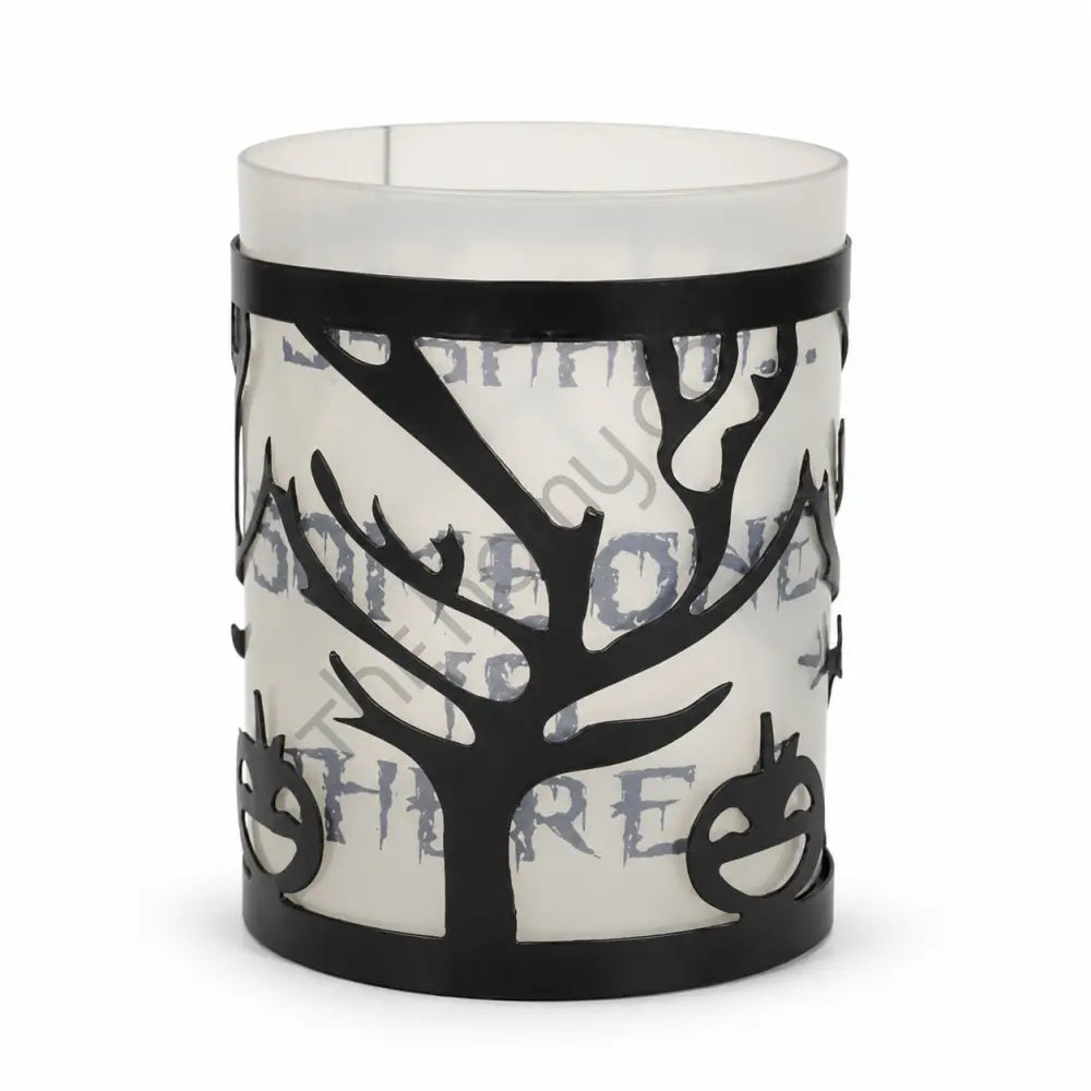 Black metal Halloween tree candle holder with frosted glass and haunted branch cutouts for spooky tabletop decor.