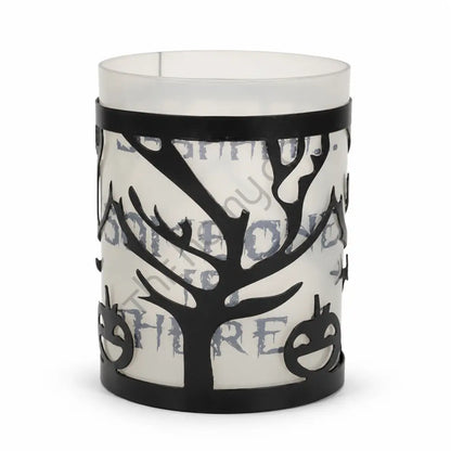Black metal Halloween tree candle holder with frosted glass and haunted branch cutouts for spooky tabletop decor.