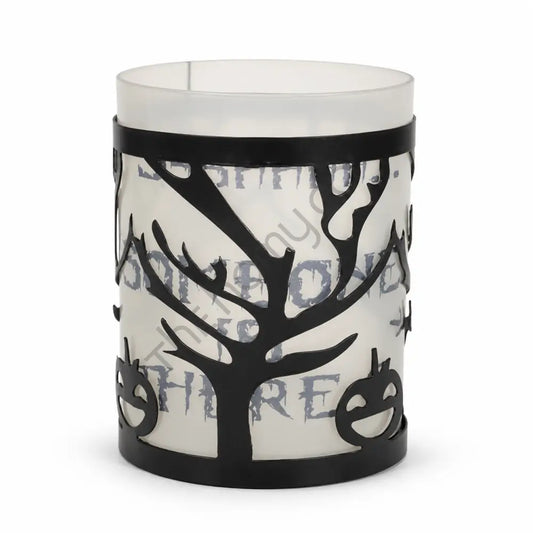 Black metal Halloween tree candle holder with frosted glass and haunted branch cutouts for spooky tabletop decor.