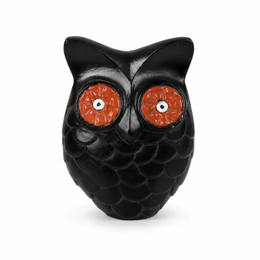Handcrafted black owl figurine with red eyes and detailed feathers for table decor.