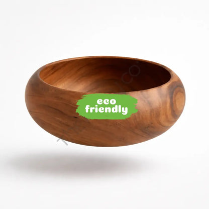 Handcrafted wooden serving bowl with natural wood grain for salads and fruits in a rustic kitchen setting.