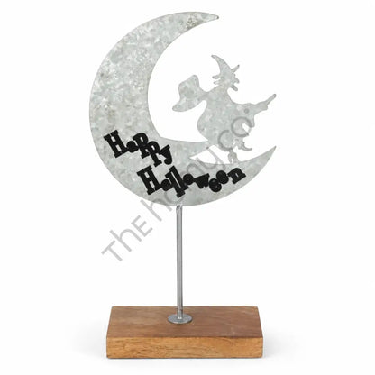 Happy Halloween moon witch silhouette on a crescent moon with a rustic galvanized metal finish and wooden base for tabletop decor.