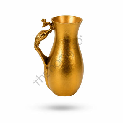 Luxury gold metal pitcher vase with a sculpted peacock handle and textured metallic finish for elegant home decor.