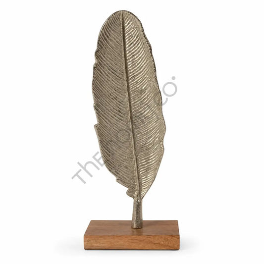 Modern gold metal leaf sculpture on a solid wooden base for contemporary home and office tabletop decor.