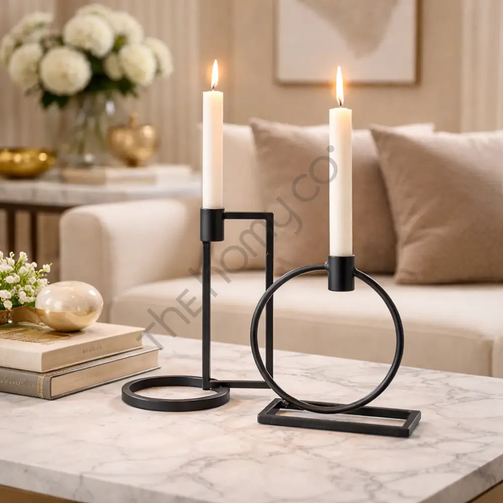 Minimalist set of two geometric black metal candle holders for modern home decor and taper candles.