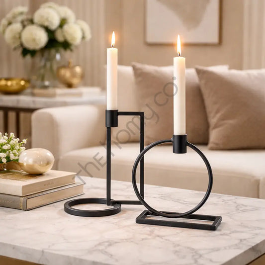Minimalist set of two geometric black metal candle holders for modern home decor and taper candles.