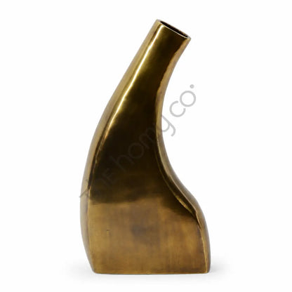 Modern abstract gold sculptural flower vase with a sleek metallic finish for contemporary home decor.