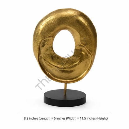 Modern abstract gold sculpture with a textured circular design on a matte black base for contemporary home decor. - 3