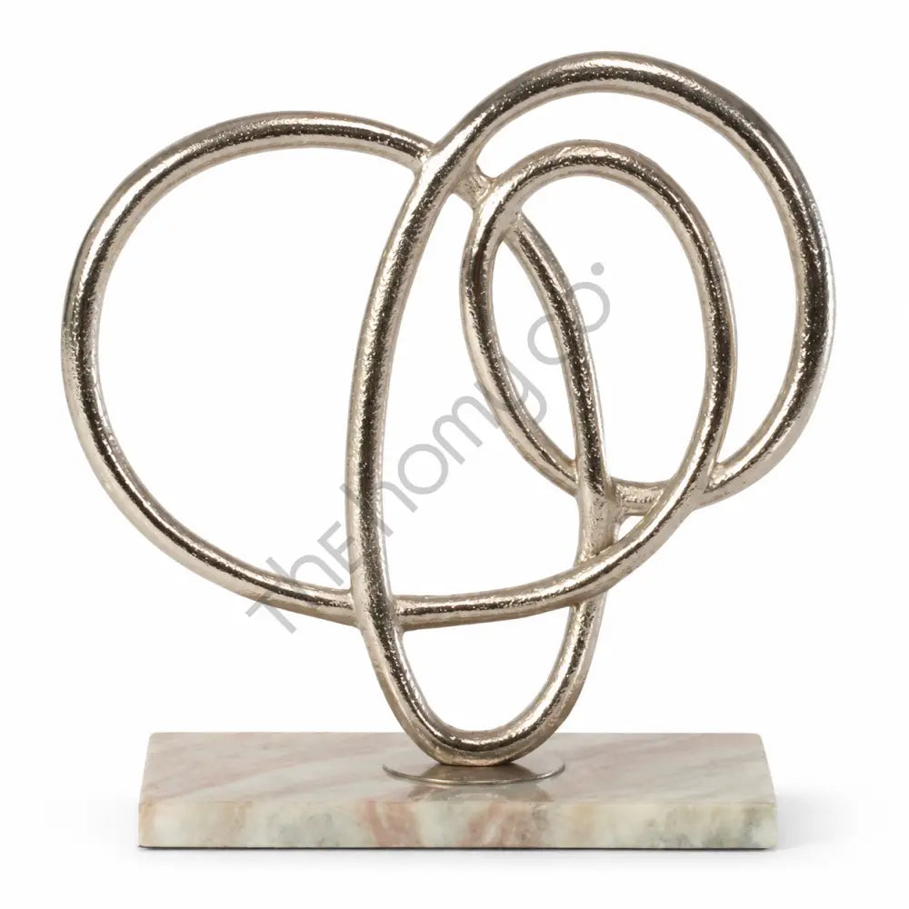 Modern abstract metal ring sculpture on a marble base for contemporary tabletop art decor.