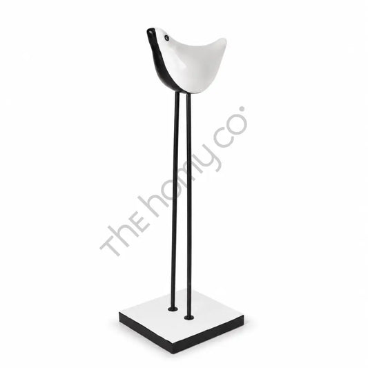 Modern minimalist black and white bird sculpture on a metal stand for tabletop decor.