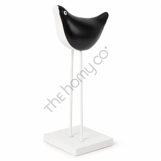 Elegant black and white metal bird figurine on a sleek stand for modern tabletop decor.