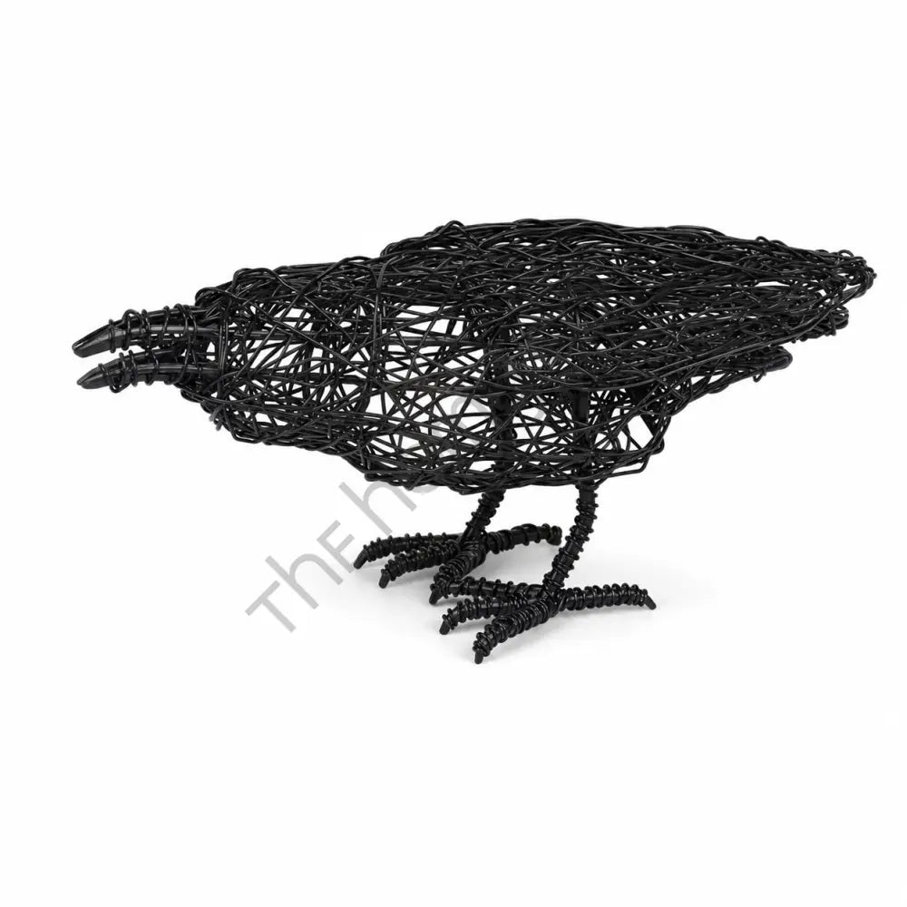 Handcrafted matte black wire crow sculpture with a minimalist open-frame design for modern tabletop decor.