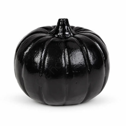 Modern glossy black pumpkin decoration with a sculpted design for minimalist Halloween home decor.