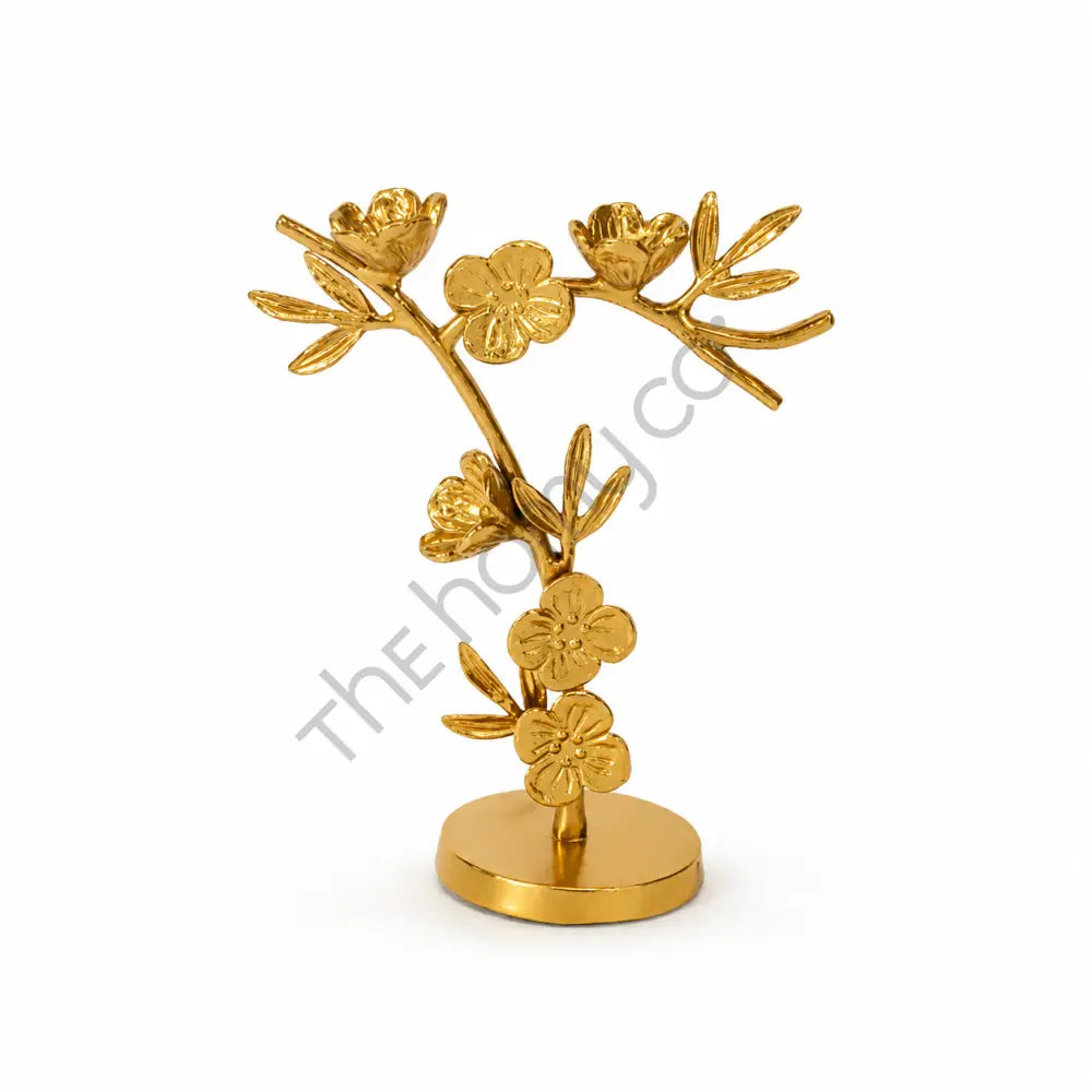 Modern gold metal floral branch sculpture with blooming flower details for contemporary tabletop home decor.