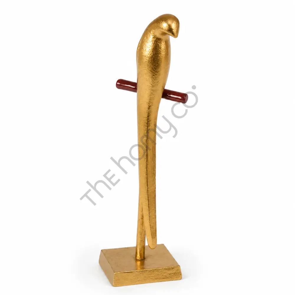Modern gold metal parrot sculpture on a sleek stand for contemporary home and office decor.