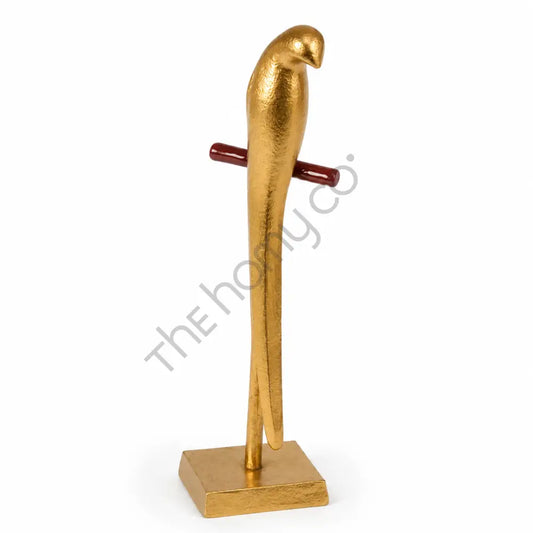 Modern gold metal parrot sculpture on a sleek stand for contemporary home and office decor.
