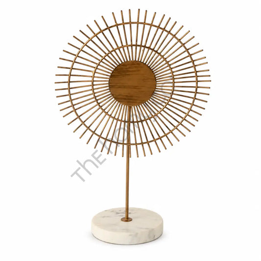 Modern sunburst gold metal table sculpture with marble base and wooden center for home and office decor.