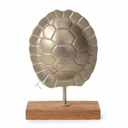 Modern metal turtle shell sculpture on a natural wooden base for elegant tabletop and office decor.