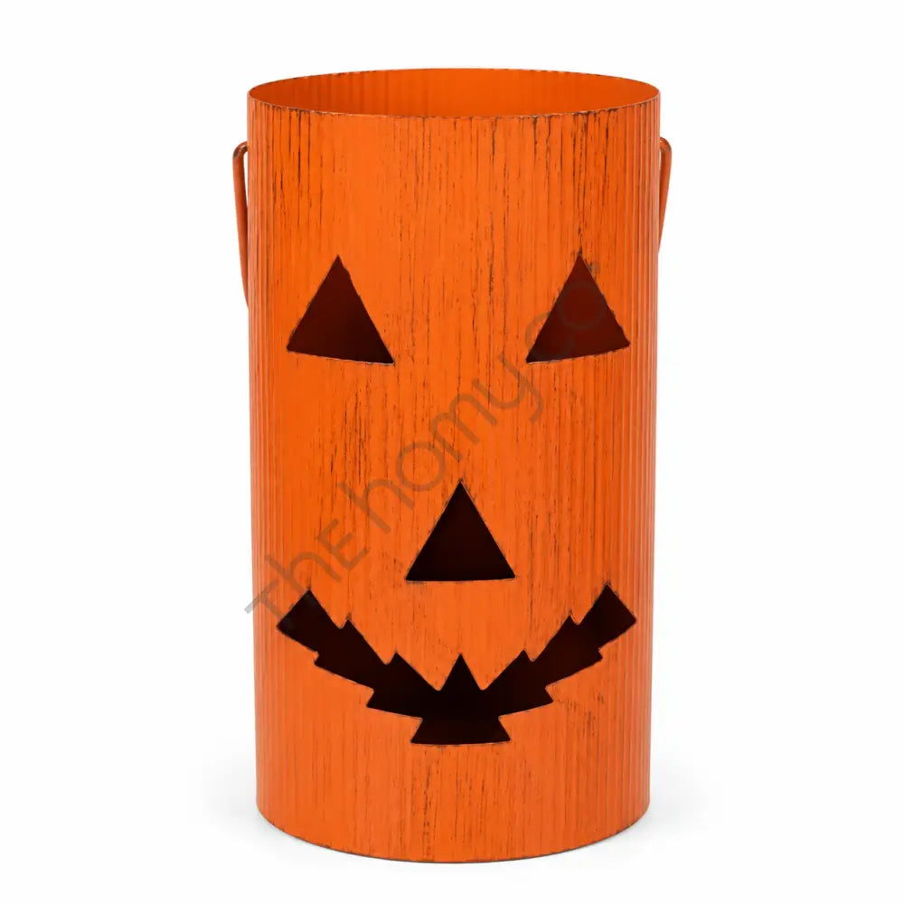 Rustic orange jack-o-lantern metal bucket with spooky pumpkin face cutout for Halloween lantern decor.