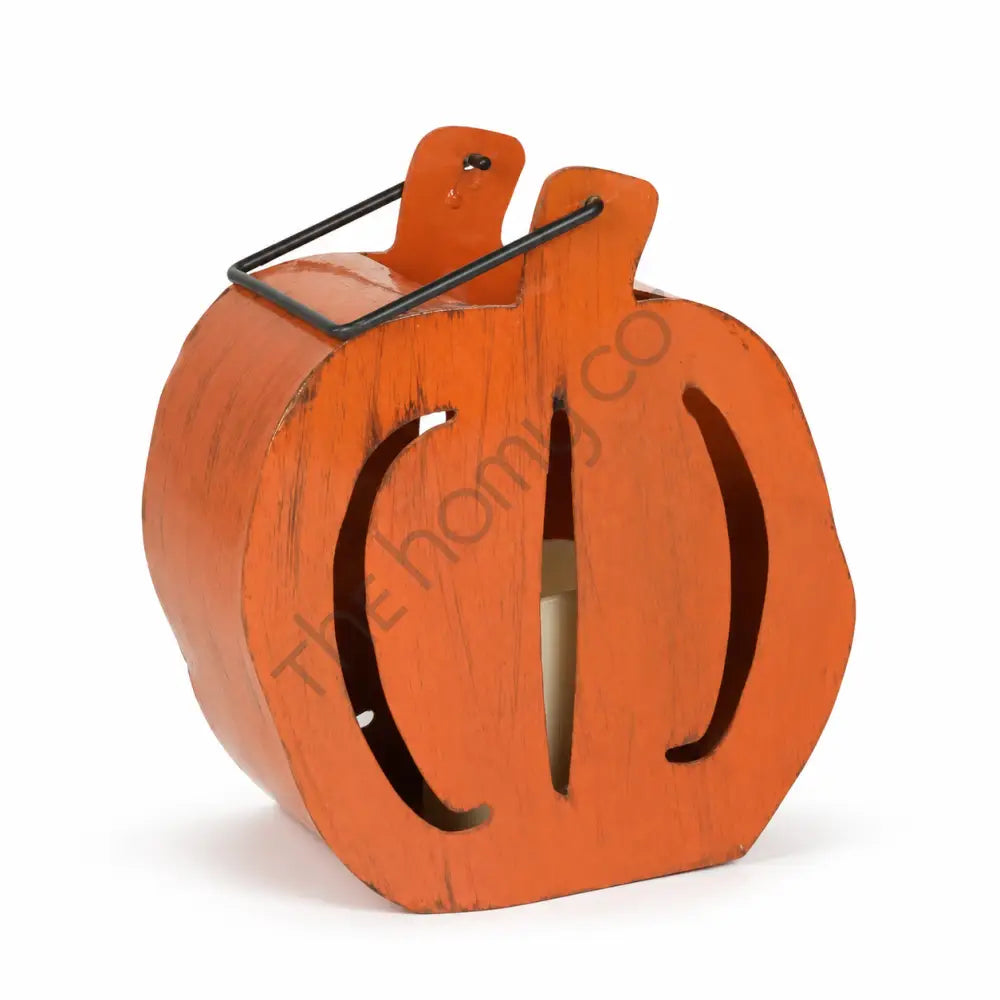 Rustic orange pumpkin Halloween lantern with a metal handle for farmhouse-style holiday decor.