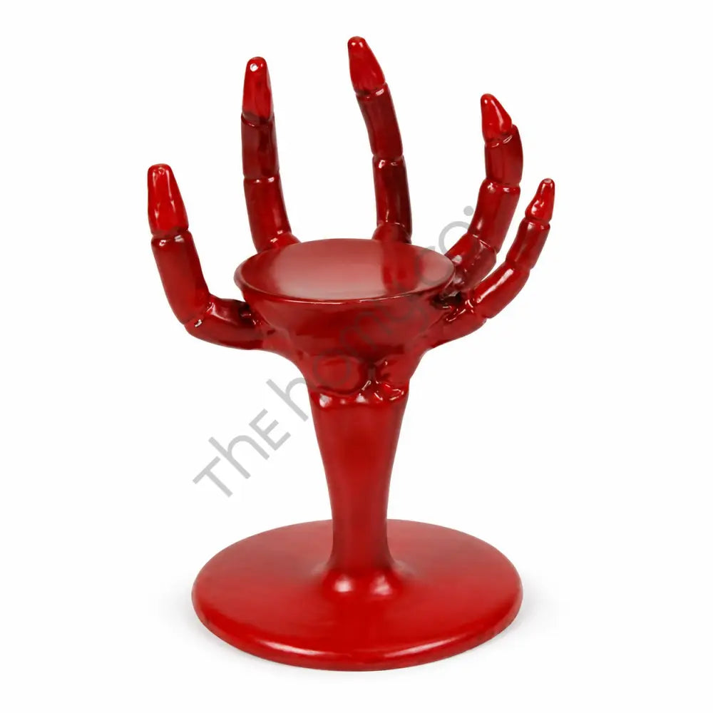 Red skeleton hand candle holder stand for gothic Halloween decor.