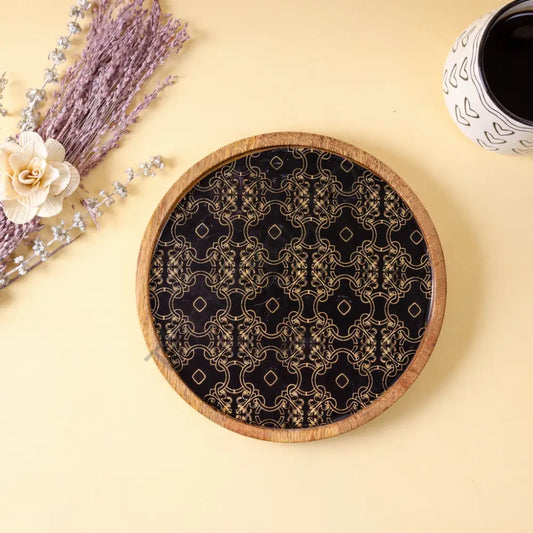 Round wooden serving tray with elegant decorative decal for snacks and tea.