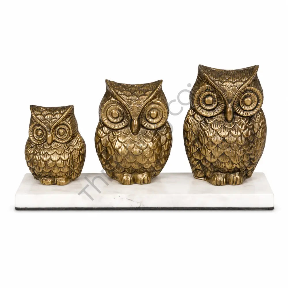 Set of 3 golden owl figurines with antique gold finish on premium marble bases for home and office decor.