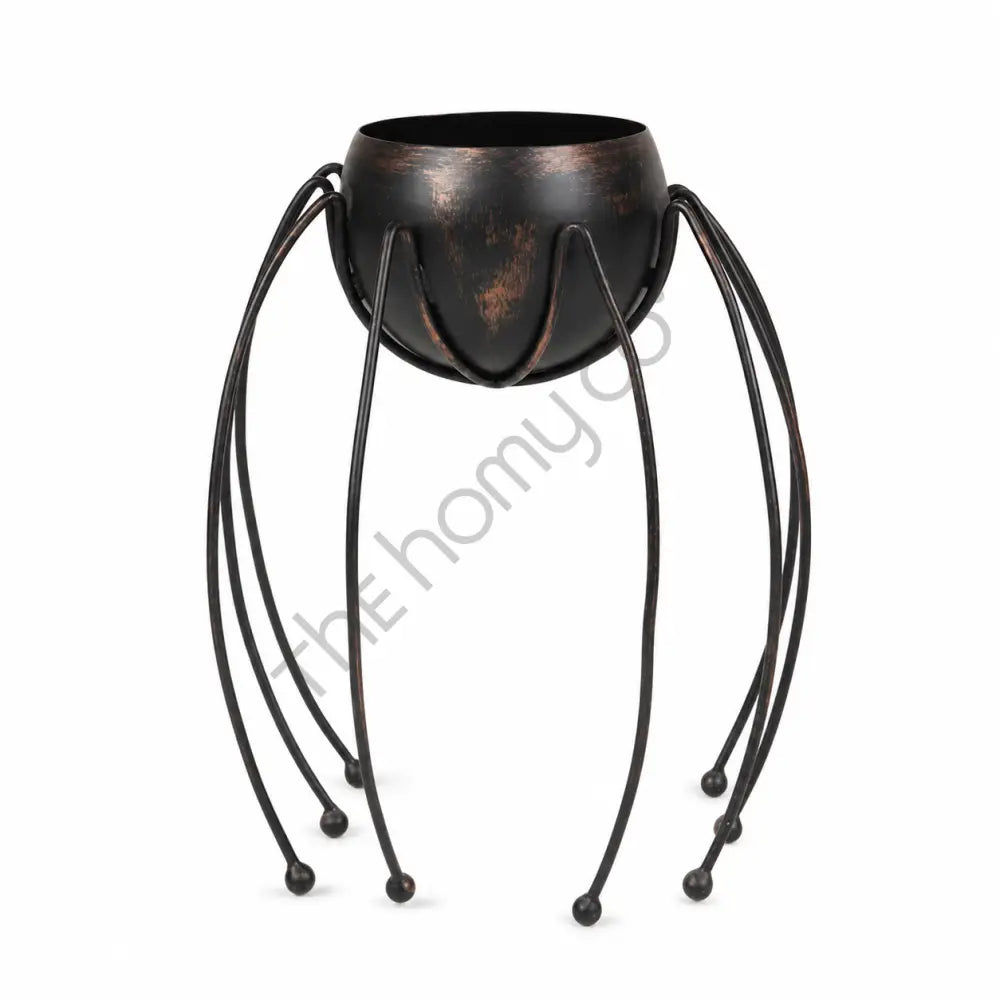 Black spider-shaped metal planter and candy bowl with long legs for Halloween home decor.