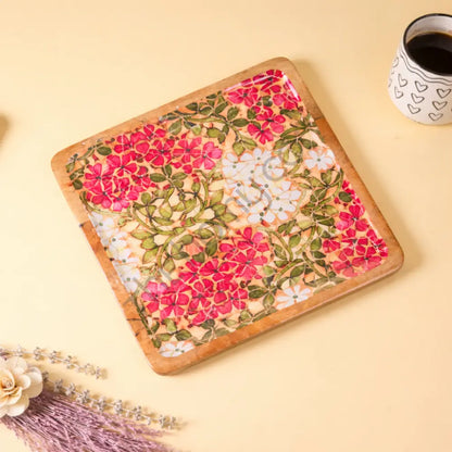 Square wooden serving platter with vibrant floral decaling for appetizers and snacks.